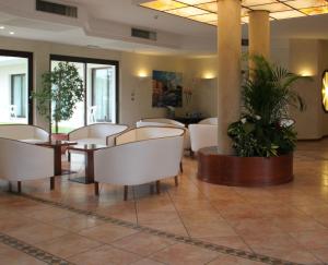 a large room with a large table and chairs at Hotel Porto Azzurro in Sirmione
