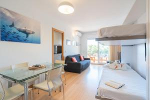 a living room with a bunk bed and a desk at Apartamento Serenity in Cunit