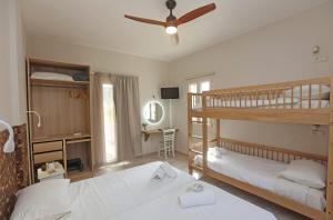 a bedroom with two bunk beds and a desk at Ventoura Studios & Apartments in Galissas +126 photos
