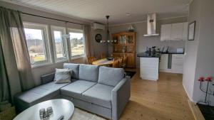 a living room with a couch and a kitchen at Ebbas i Överboda in Överboda