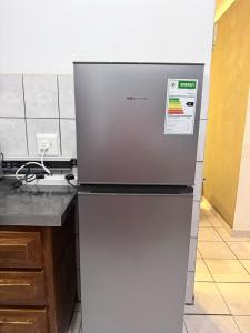 a refrigerator freezer sitting on top of a kitchen counter at SeaBreeze Sanctuary in Richards Bay