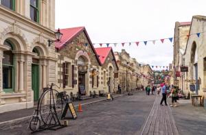 a city street with buildings and people walking on the street at Affordable On Arun in Oamaru