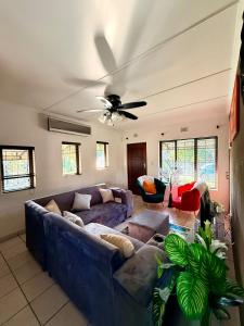 a living room with a couch and a ceiling fan at SeaBreeze Sanctuary in Richards Bay
