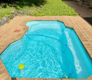 a swimming pool with a yellow ball in the water at SeaBreeze Sanctuary in Richards Bay