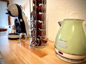 a tea kettle sitting on top of a wooden counter at Casa del Sorriso in Costa +22 photos