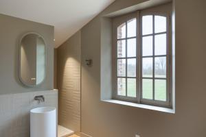 a bathroom with a sink and a window at Moulin de Cazaux-Savès in Cazaux-Savès