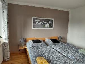 a bedroom with two beds and a picture on the wall at Ferienwohnung Lorke in Thiersheim