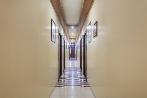 a hallway of a building with doors and tile floors at Treebo Royal Empire in Chinchwad