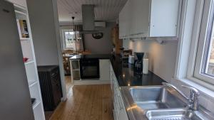 a kitchen with a sink and a counter top at Ebbas i Överboda in Överboda +40 photos
