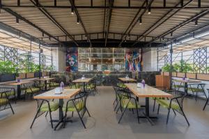 a restaurant with tables and chairs in a room at Treebo Royal Empire in Chinchwad