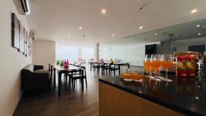 a bar with glasses of orange juice on a counter at ZEN Medicity - Boutique Hotel Gurgaon in Gurgaon