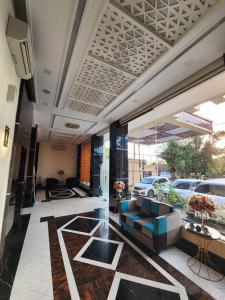 a lobby with a blue couch in a building at hotel diana in Banda Aceh