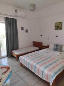 a bedroom with a bed and a couch in it at Vangelis rooms in Pitsidia
