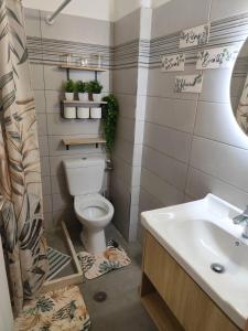 a bathroom with a toilet and a sink at Vangelis rooms in Pitsidia