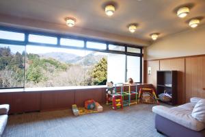 a living room with a large window with a mountain view at Shiki Resort Villa Hakone 80 in Hakone
