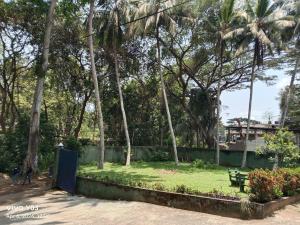 a park with palm trees and a bench at New Olina Gest and Restaurant in Wellawaya