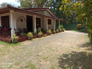 a house with potted plants in front of it at New Olina Gest and Restaurant in Wellawaya