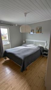 a bedroom with a bed in a room with a window at Ebbas i Överboda in Överboda