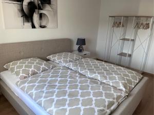 a bed with a comforter and pillows in a bedroom at Ferienwohnung 1A in Fockendorf