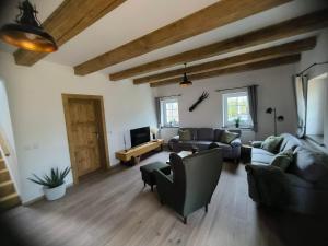 a large living room with couches and a tv at Chalupa na Kopci in Liberec