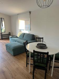 a living room with a couch and a table at Apartman Lea in Sibinj