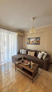 a living room with a couch and a coffee table at Anesis home in Gythio