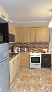a kitchen with wooden cabinets and a white stove top oven at Anesis home in Gythio