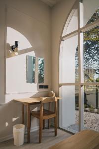 a dining room with a table and a window at La Kana Boutique Villa in Kamphaeng Phet