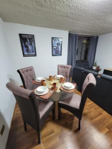 a dining room table with chairs and a table and a table and chairsktop at Llama House Cusco in Cusco