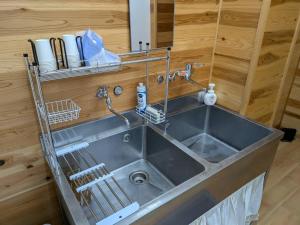 a kitchen sink with a faucet on top of it at hostel 丹鶴 in Shingū +26 photos