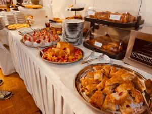 a buffet with many different types of food on a table at Hotel Principe in Sanremo +94 photos