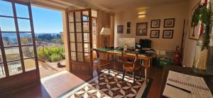 a room with a desk with a computer and a window at Villa Palazzo Delle Erbe in Casole dʼElsa