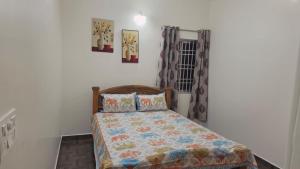 a bedroom with a bed and a window at June Villa Feel at Home at yelagiri hills in Yelagiri