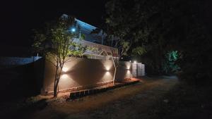 a building with lights on the side of it at night at June Villa Feel at Home at yelagiri hills in Yelagiri