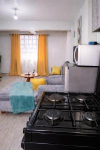 a kitchen with a stove top in a living room at Esidai Sidai in Narok
