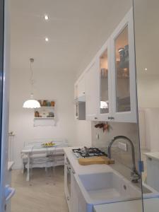 a white kitchen with a sink and a stove at Marè Sunrise in Bari +73 photos