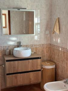 a bathroom with a sink and a mirror at Casa Miramar in Tavira +29 photos