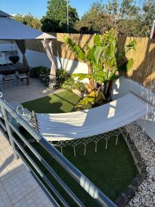 a hammock in the middle of a garden at Casa Miramar in Tavira