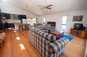 a living room with two couches and a table at Cambroe in Lakes Entrance