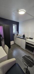 a room with a kitchen with a couch and a table at Room dream in Wiltz