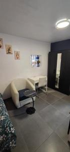 a room with a couch and a table and a desk at Room dream in Wiltz