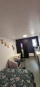 a bedroom with a bed and a chair and a desk at Room dream in Wiltz