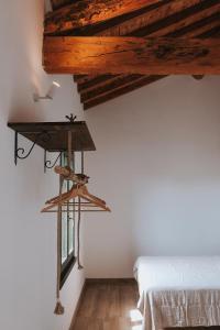 a bedroom with a bed and a wooden ceiling at Tenuta La Macina in Polpenazze del Garda +20 photos