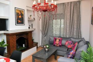 a living room with a couch and a fireplace at Art House by Helen in Soroni Rhodes in Rhodes Town