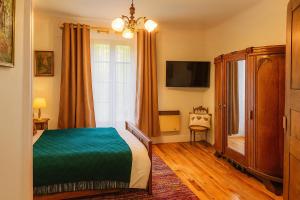 a bedroom with a bed and a tv and a window at Chez jacky in Serres +4 photos