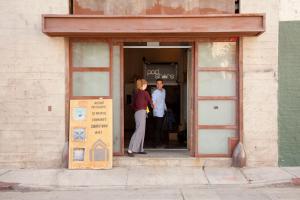 two people standing in the doorway of a building at PodShare Hollywood in Los Angeles