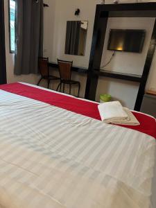 a bedroom with a bed with a red and white blanket at Sk Phuket Old Town in Phuket