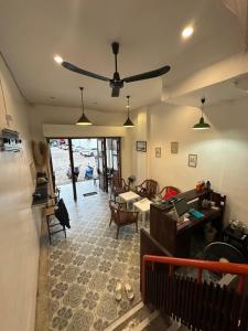 a living room with a ceiling fan and a table at Sk Phuket Old Town in Phuket