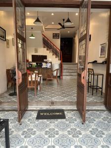 an open door to a dining room and a kitchen at Sk Phuket Old Town in Phuket