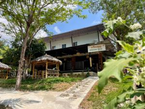 a building with a gazebo in front of it at Green Gen Hotel Phuket in Phuket